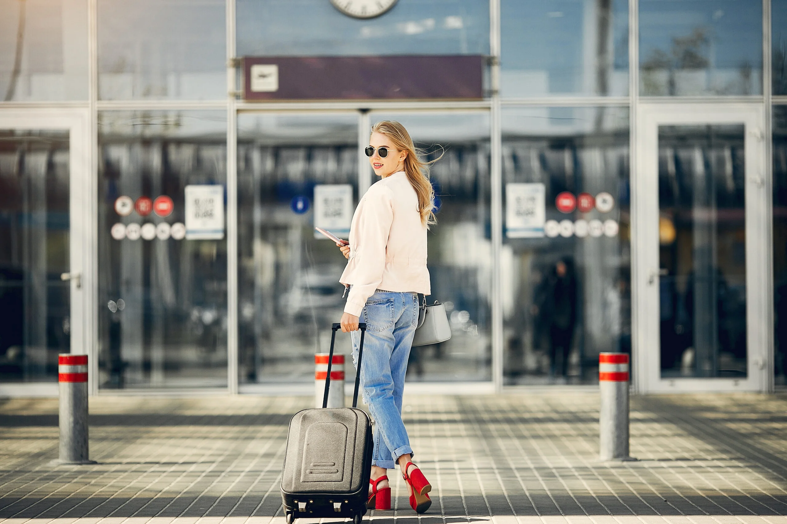 beautiful girl standing in a airport and waiting knutford taxis driver